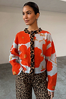 Blue Poppy Cardigan with orange poppy print and leopard trim, styled with leopard print jeans.