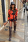Thumbnail for Black Poppy Cardigan with a bright red poppy print, styled with tall boots for a street style London look.