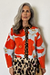 Pale blue Poppy Cardigan with orange floral print and leopard trim, styled with a leopard print skirt.