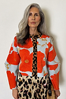 Pale blue Poppy Cardigan with orange floral print and leopard trim, styled with a leopard print skirt.