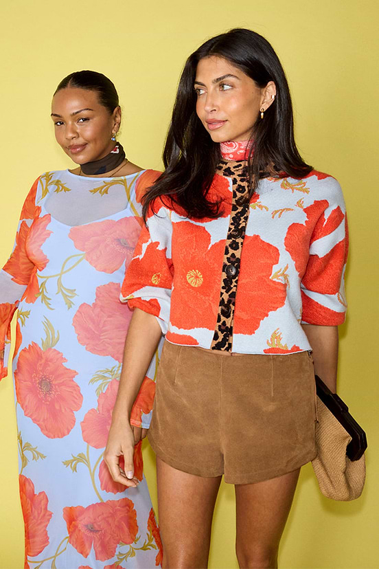 Blue Poppy Cardigan with bold poppy print and leopard trim, shown on two models for inclusive sizing.