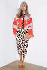 Blue Poppy Cardigan with a red poppy print and leopard trim, styled with a leopard midi skirt on a silver-haired model.