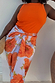 Thumbnail for Iconic Blue Poppy Jaspre Skirt with orange floral print and wrap tie fastening on a size 16 model.