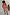 Thumbnail for Blue Poppy Jaspre Skirt with orange floral print, styled as a wrap skirt with a bright orange ribbed vest.