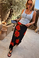 Black Poppy Midi Maeva Skirt in a red poppy and polka dot print with lace trim, styled in a sunny garden.