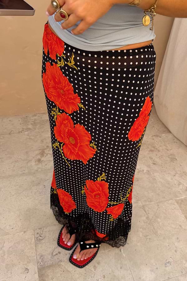Black Poppy Midi Maeva Skirt with large red poppies, white polka dots, and a delicate black lace hem.