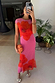 Pink Poppy Sleeveless Mesh Dress featuring iconic red floral prints, styled in a mirror selfie with an orange clutch.