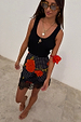 Black Poppy Mini Maeva Skirt featuring a polka dot and poppy print with a black lace trim at the hem.