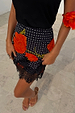 Black Poppy Mini Maeva Skirt in an iconic floral and polka dot print with a delicate black lace hem.