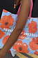 Limited run Blue Poppy Gift Bag with orange floral print and pink handles, featuring the feel good dressing slogan.