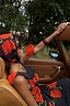 Black Poppy Sophie Dress with red poppy print and polka dots, worn with a matching headscarf in a vintage car.