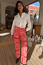 Thumbnail for Red Bandana Jeans Petite featuring a white paisley pattern and straight-leg fit, styled with a long-sleeved white shirt.