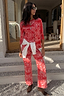 Thumbnail for Red bandana print straight leg jeans and cardigan co-ord, styled with a white shirt tied at the waist.