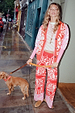 Red Bandana Martha Cardigan in a red and pink knit bandana print, styled as a co-ord on a London street.