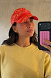 Red Bandana Cap featuring a pink embroidered NFD logo, styled with a yellow ribbed sweater on a model.