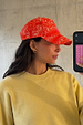 Red Bandana Cap in a white paisley print, styled with a yellow sweatshirt in a casual mirror selfie.