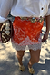 Thumbnail for Red Bandana Maeva mini skirt featuring an iconic print and white lace border, styled with a white shirt.