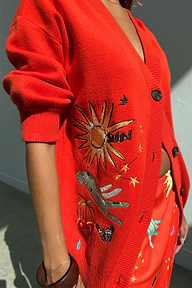 Red Celestial Cardigan featuring embroidered sun, heart and palm motifs on a soft knit with button-up front.