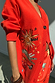 Red Celestial Cardigan featuring embroidered sun, heart and palm motifs on a soft knit with button-up front.