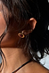 Deloris Red Circle Earrings in textured brushed brass with a red semi-precious stone, shown on a model.