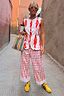 Cream Marina Marra Trousers in a red fish print, styled as a co-ord on a 5ft4 model in UK size 8/US 4.
