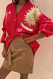 Tan brown Suede Mini Jaspre Skirt in a wrap style paired with a red mystical sun print cardigan.