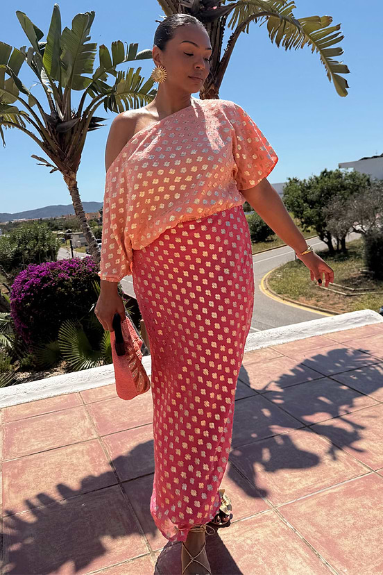 Pink and red off-the-shoulder Tilly Dress in metallic jacquard with gold dots, featuring inclusive sizing for vacation.