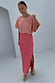 Pink and red jacquard Tilly dress with gold dots and a side slit, worn by a model.