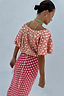 Back view of the pink and red jacquard Tilly Dress Petite with gold specks and an off-the-shoulder neckline.
