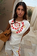 Snake Asymmetric Top in white with a red checkered snake print, star motifs and gathered waist detailing.