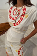 Snake Asymmetric Top in white with red and yellow snake print, star motifs and a gathered waist.