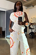 White Snake Asymmetric Top with red snake and star motifs, styled as a co-ord in a mirror selfie.