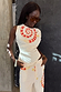 Snake Asymmetric Top in white with a red chequered snake print and star motifs, paired with matching trousers.