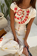 Snake Asymmetric Top featuring a red and yellow spiral print and star motifs, styled as a feel-good co-ord.