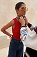 Red ribbed tank top styled with dark denim jeans, yellow sunglasses and a patterned neck scarf.