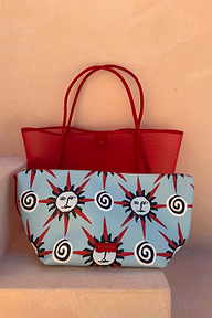 Red Mesh Tote Bag with leather handles and a light blue sun-print pouch on a neutral stone step.