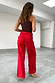 Red Denim Scallop Jeans with wide legs and scalloped back pocket details, styled with a brown top and heels.