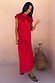 Red Darcy midi dress in bright cotton featuring a dropped waist and collared neckline, styled beside a clay vase.