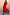 Thumbnail for Red Darcy cotton midi dress featuring a dropped waist and collared neckline, standing beside a large ceramic vase.