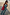 Thumbnail for Red Wiggle Arm Acetate Sunglasses with red tortoise frames and dark lenses, styled with a blue sun-print co-ord and red bag.