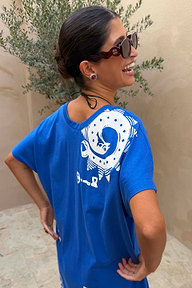 Red Wiggle Arm Acetate Sunglasses with red tortoise frames and dark lenses, worn with a blue graphic t-shirt.