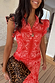 Red Bandana Remi Dress featuring leopard sleeve frills and tortoise buttons on a model with a leopard clutch.