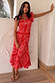 Red Bandana Remi Dress with leopard print frill sleeves and a pleated neckline, shown on a model.