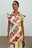 Fruit Stamps Remi Dress in white cotton-linen featuring ruffled sleeves and a fruit sticker print.