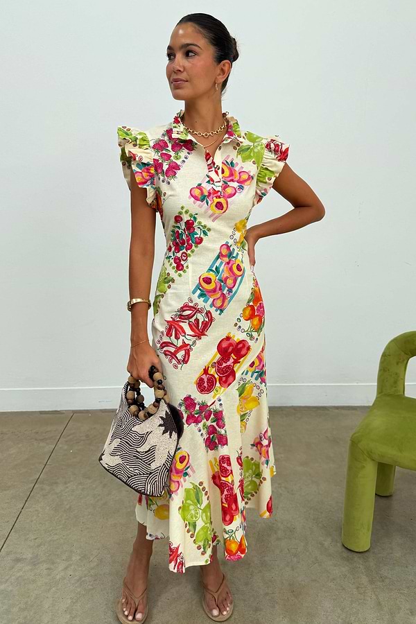 Fruit Stamps Remi midi dress in white cotton-linen with ruffle sleeves, a buttoned collar and colourful fruit motifs.