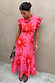 Pink Soleil Remi Dress featuring red sun motifs, pleated frill sleeves and an asymmetrical skirt on a model.