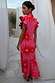 Pink Soleil Remi Dress with red sun motifs, pleated frill sleeves with leopard lining and an asymmetrical skirt.