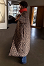Thumbnail for Leopard print quilted reversible coat with a red collar and longline fit, designed for multi-wear styling.