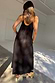 Thumbnail for Black Rio Maxi Dress from the back, with thin adjustable straps and lightweight fabric featuring subtle tropical motifs.