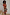 Thumbnail for Rio Mesh Dress featuring oversized fruit motifs and warm colour blocks on a stretch mesh base, styled on a model.
